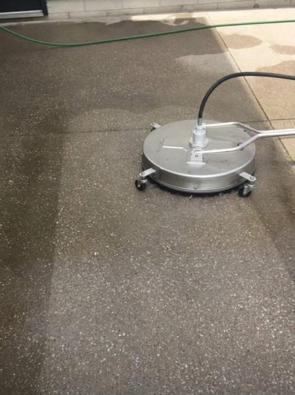 A house exterior being powerwashed.